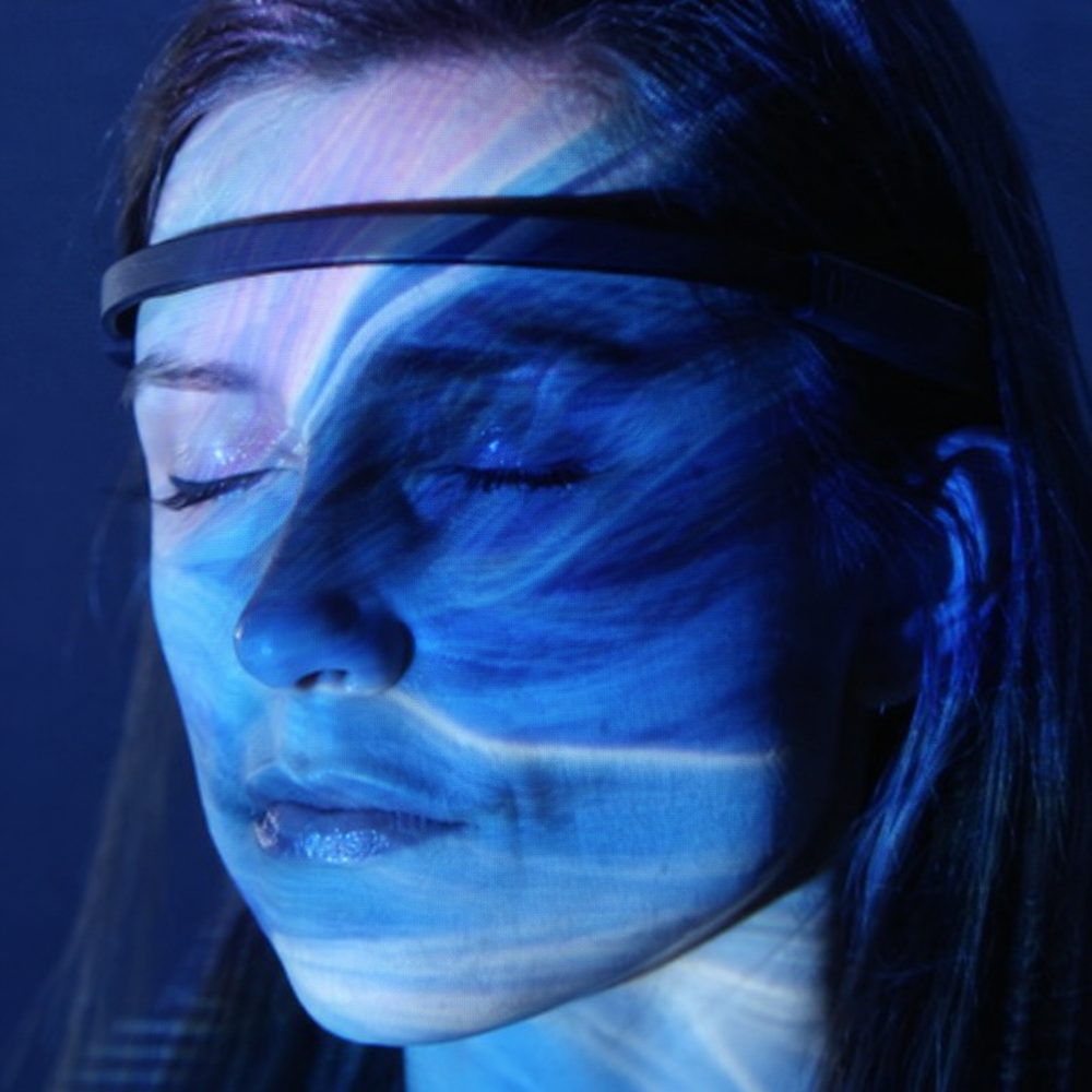 The Art of Feeling: woman wearing an EEG headband with projected colour across her face
