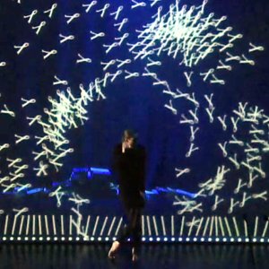 Book Awards: performer on stage surrounded by projected animated graphics