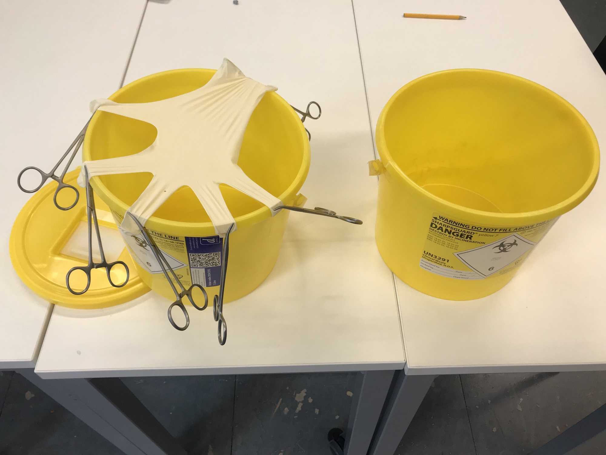 Surgical scissors and sharps bins used to build the marble runs